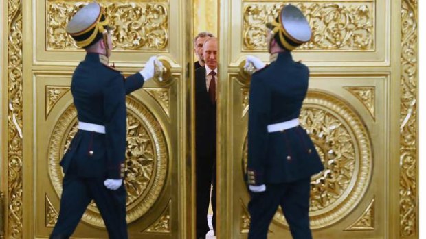 Doors open for Putin: The Russian President enters hall for the signing ceremony.