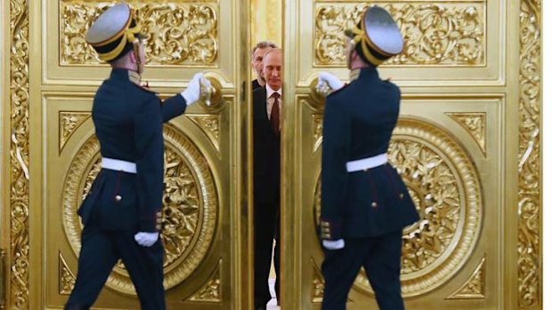 Doors open for Putin: The Russian President enters hall for the signing ceremony.