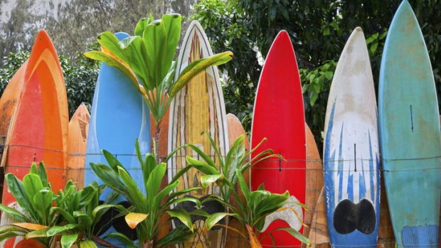 A colourfully painted surfboard fence.