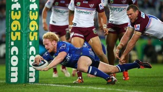 Dog gone: Canterbury prop James Graham evades Manly to score.
