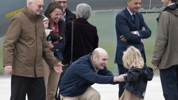 Nicolas Henin, centre, meeting his daughter upon his arrival in France. 