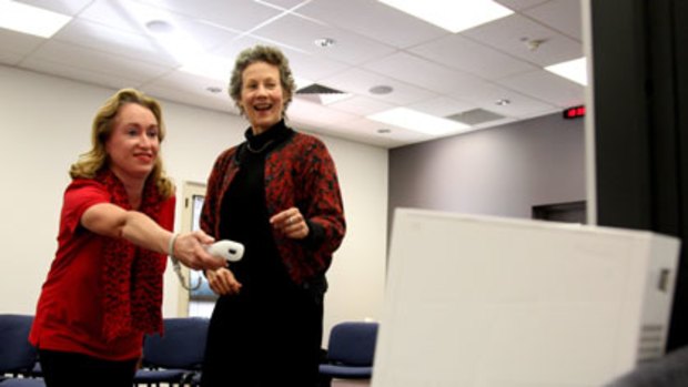 Help at hand ... stroke patient Marianne McDonald uses the Wii as therapy with Dr Penelope McNulty.