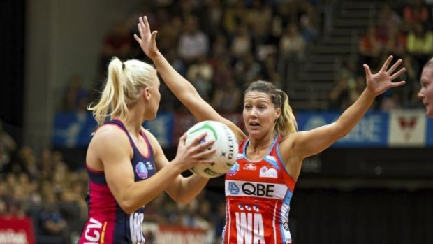 NSW Swifts wing attack tries to prevent a Melbourne Vixens attacking raid.