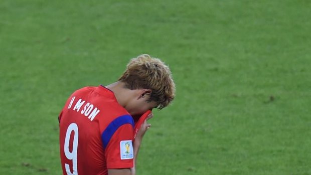 South Korea's midfielder Son Heung-Min reacts at the end of the Group H football match between South Korea and Algeria. 