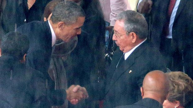 US President Barack Obama shakes hands with Cuban President Raul Castro at Nelson Mandela's memorial.
