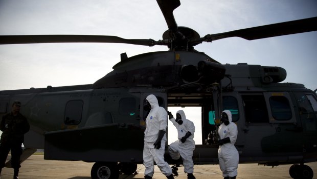 Military medical personnel in suits attend a drill, simulating a biological or nuclear attack, at Galeo Air Base in Rio de Janeiro. Security preparations for the upcoming Rio de Janeiro Olympics are to be reviewed following the Nice attack.