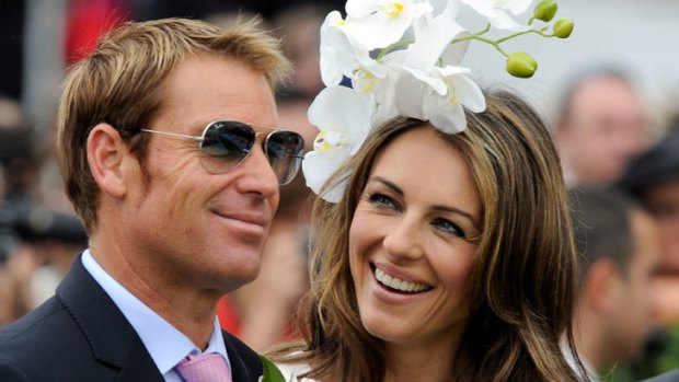 Liz Hurley with Shane Warne at Crown Oaks Day at Flemington.