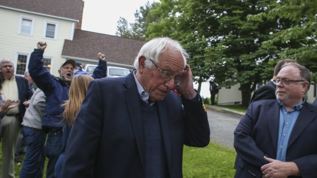 Democratic presidential candidate, Senator Bernie Sanders walks away after speaking at a news conference outside his home on Sunday.