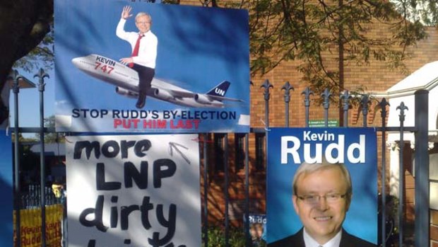 Dirty tricks: Signage wars broke out yesterday at Brisbane polling booths.