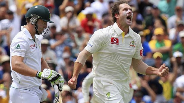 John Hastings celebrates his first Test wicket, that of A.B. de Villiers.