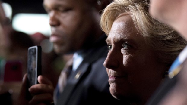 Democratic presidential candidate Hillary Clinton greets members of the audience after speaking at a rally at Theodore Roosevelt High School.