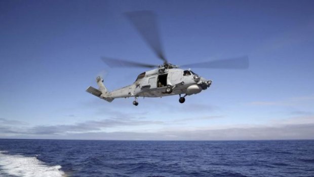 A S-70B-2 Seahawk launches from HMAS Toowoomba as it continues the search in the southern Indian Ocean for the missing Malaysian Airlines flight MH370.