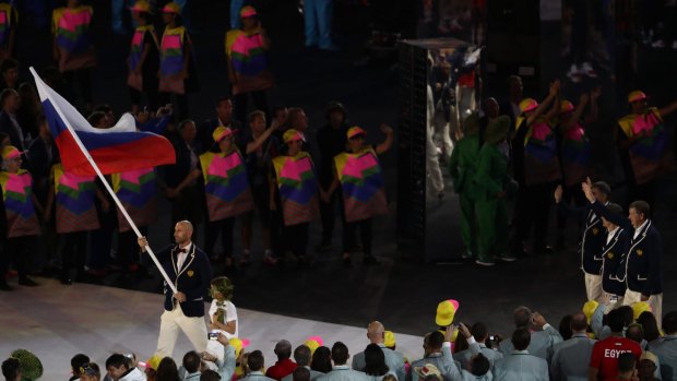 Russian flagbearer Sergei Tetiukhin leads the team during the Olympic opening ceremony at Maracana.
