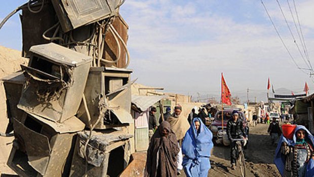 Women walk past old electricity meter boxes in the Afghan capital, Kabul.