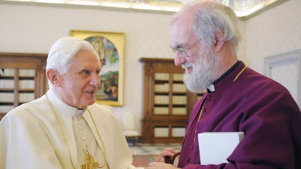 Pope Benedict XVI L shakes hands with Archbishop of Canterbury Rowan Williams.