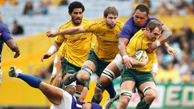 Blue Sunday ... Wallabies captain Rocky Elsom, who missed the majority of the Super Rugby season with injury, struggles to fight his way through the physical Samoan defence.