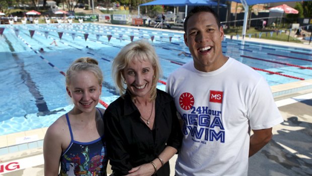 Smiles ... MS Mega Swim ambassador Geoff Huegill with Bianca Richmond, swimming for mum Leiza.