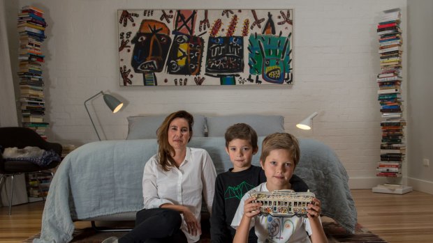 Fiona Larwill, with sons Henry, 8, and Jimmy, 12, with a ceramic replica of David Larwill's art tram.