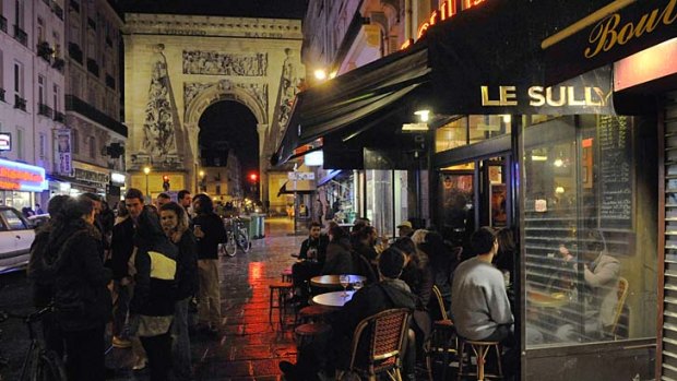 Customers have a drink outside the bar Le Sully on Rue Du Faubourg Saint-Denis in Paris.