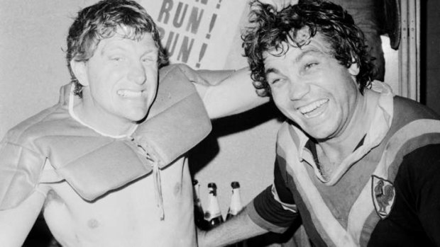 Ron Coote (left) and Arthur Beetson share the joys of victory in the dressing-room in 1975.