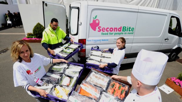 SecondBite workers collect leftover food from Birdcage Marquee at Flemington racecourse.