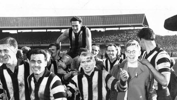 Collingwood players carry acting captain Murray Weideman off the field after he was instrumental in the Magpies scoring an upset win over Meelbourne in the 1958 grand final.