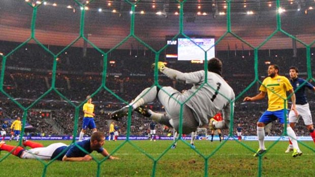 The winner . . . Karim Benzema (L) looks up after scoring a goal past Brazil's goalkeeper Julio Cesar.