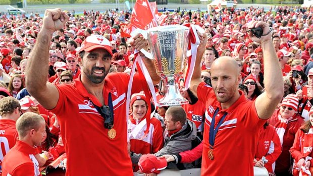Flag bearers &#8230; co-captains Adam Goodes and Jarrad McVeigh lift the premiership cup.