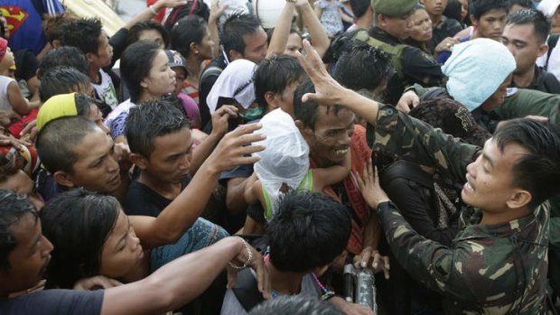 Desperation:  Typhoon survivors jostle to board an evacuation plane.