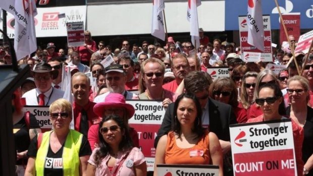 Seeing red: At a rally in Canberra a couple of thousand public servants turned up at lunchtime, many wearing red, to hear the battle rhetoric from union leaders which could reverberate through Commonwealth departments dealing with every Australian.