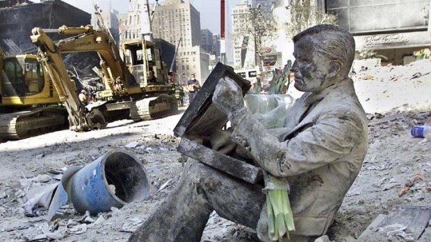 Frozen in time ... a bronze statue covered in dust amid the rubble.