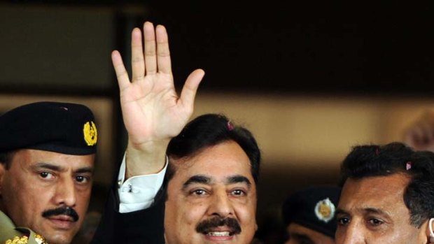 Free will ... Prime Minister Yusuf Raza Gilani waves to supporters outside court before being convicted of contempt and imprisoned for just three minutes.