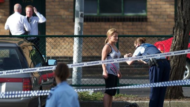 A police officer photographs a bloodstain on the shirt of a witness to the shooting of a man in the car park of the Barkly Square shopping centre in Brunswick.