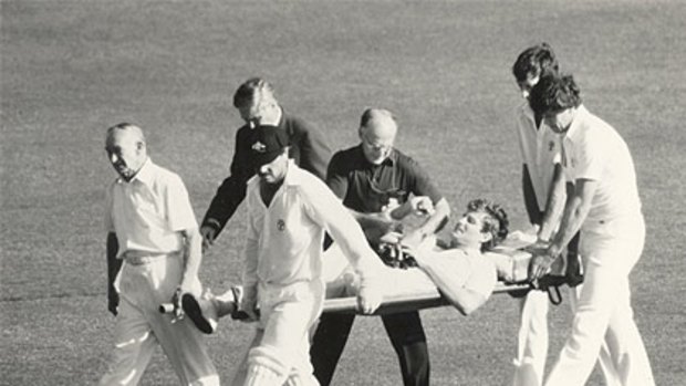 Terry Alderman is stretchered off after tackling a pitch invader.