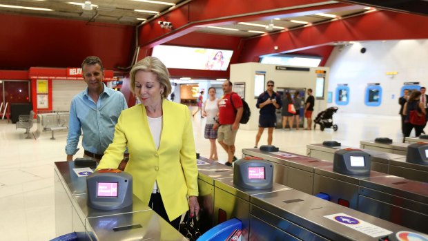 Ita Buttrose and Andrew Constance use their Opal cards at Martin Place in Sydney.