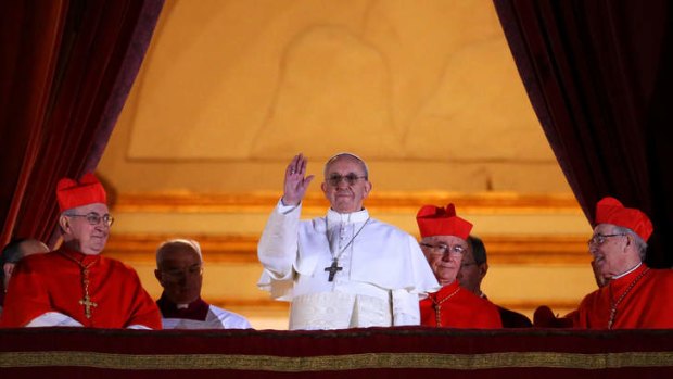 Newly-elected Pope Francis I appears on the central balcony of St Peter's Basilica.