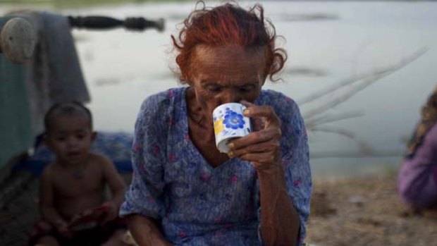 A Pakistani woman forced to flee flooding from her village drinks tea at a makeshift camp near the city of Shadad Kot, in Sindh province, southern Pakistan.