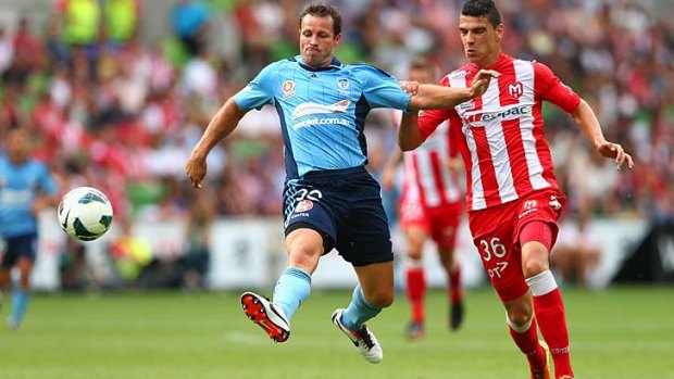 Catcalls and venom from the crowd &#8230; Lucas Neill, who spurned Heart's advances, competes for the ball against Eli Babalj on Sunday at AAMI Park.