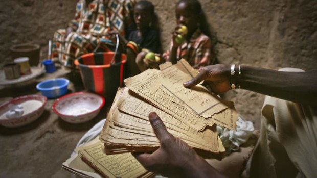 Crumbling ancient Islamic manuscripts belonging to 48-year old Fatama Bocar Sambala are shown in her mud-walled house in Timbuktu. Some owners have succeeded in removing some of the manuscripts from Timbuktu to save them and others have been carefully hidden away from the Islamists.