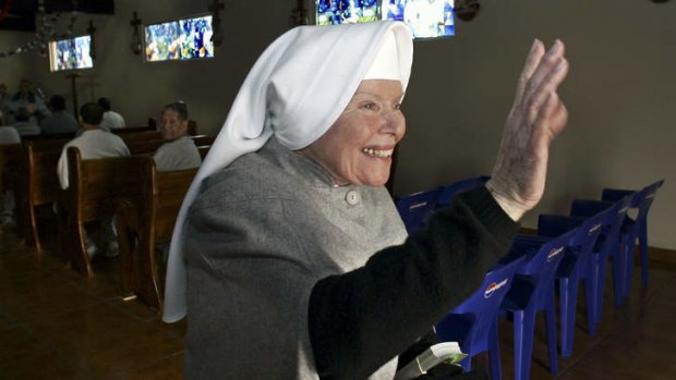 Sister Antonia Brenner, 79, known as the "prison angel," waves as she leaves the chapel at the La Mesa State Penitentiary in Tijuana, Mexico. Brenner died Thursday Oct. 17, 2013 after a long illness. She was 86.