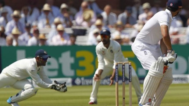 Out of form: Alastair Cook is caught by M.S. Dhoni.
