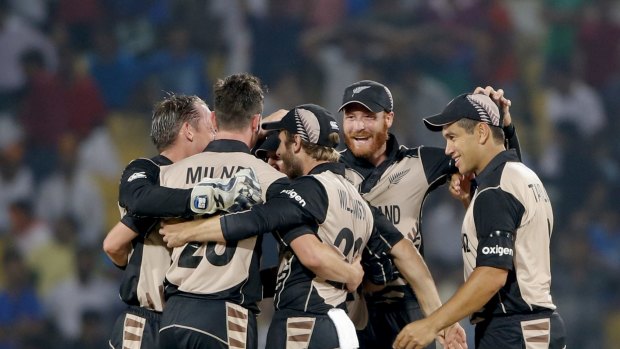 New Zealand players celebrate after defeating India by 47 runs.