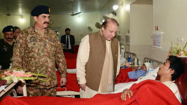 Pakistani Prime Minister Nawaz Sharif visits a student injured in the Peshawar school massacre.