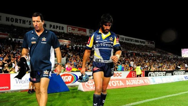 North Queensland’s worst nightmare ... Cowboys captain Johnathan Thurston leaves the field after injuring his shoulder against the Wests Tigers on Saturday night.