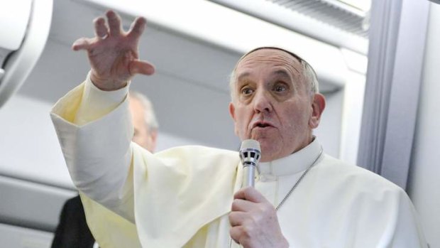 Pope Francis talks with journalists as he flies back to Rome after his visit to Brazil.