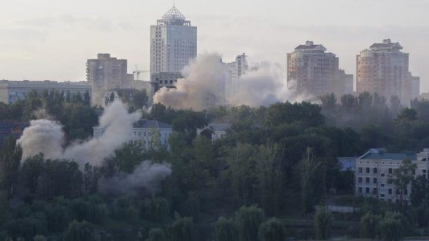 Smoke billows over a residential apartment houses following shelling in Donetsk