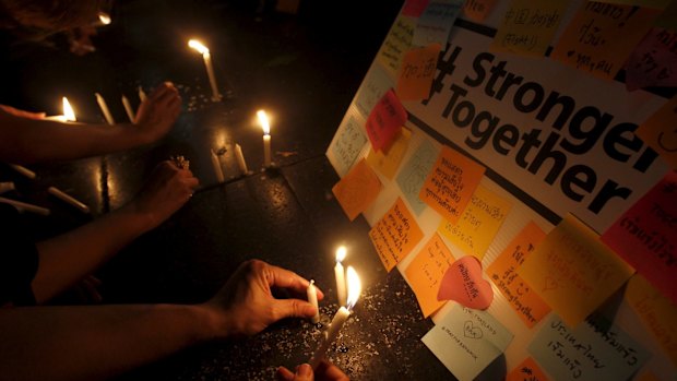 People light candles at the Erawan Shrine, the site of Monday's deadly blast, in central Bangkok.