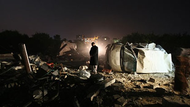 Palestinian man inspects the site of a destroyed factory after an Israeli airstrike in Gaza City overnight.