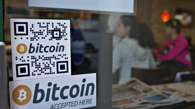 Signs on window advertise a Bitcoin ATM in Vancouver, Canada.