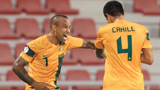 Socceroos veterans ... Archie Thompson and Tim Cahill celebrate a goal against Iraq in their World Cup qualifying match.